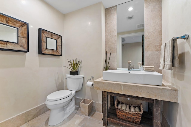 bathroom featuring vanity, tile patterned flooring, a high end fireplace, and toilet