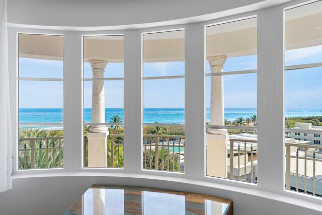 sunroom with plenty of natural light and a water view