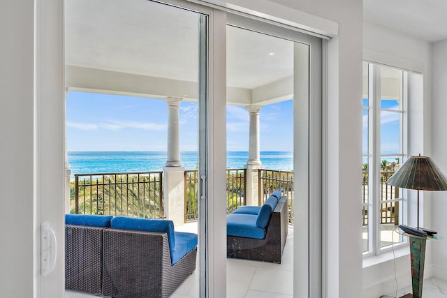 balcony with a beach view and a water view