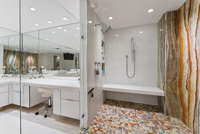 bathroom featuring vanity and independent shower and bath