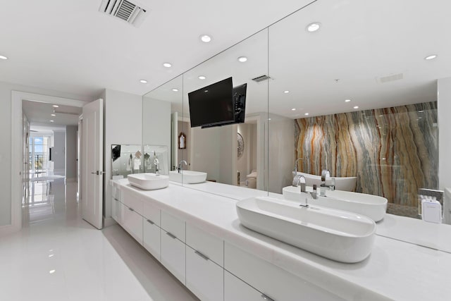 bathroom featuring tile patterned flooring, vanity, and toilet