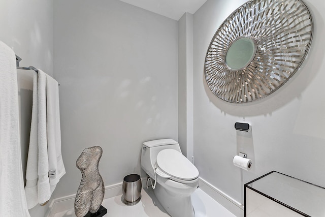 bathroom with tile patterned flooring and toilet