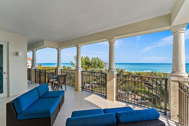 view of patio featuring a water view and a balcony