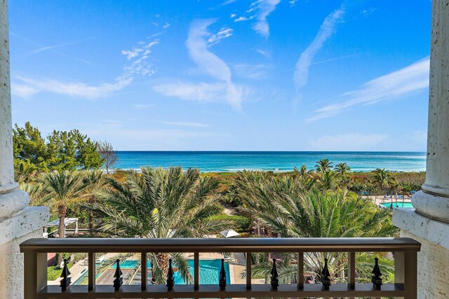 view of patio with an outdoor living space, a balcony, and a water view