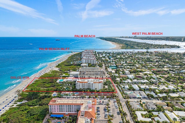 drone / aerial view with a beach view and a water view