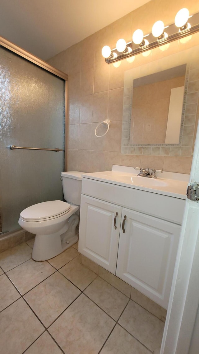 208 Easthampton I, West Palm Beach, FL 33417 - full bathroom featuring tile walls, vanity, a shower stall, tile patterned flooring, and toilet