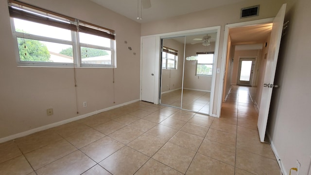 208 Easthampton I, West Palm Beach, FL 33417 - unfurnished bedroom with light tile patterned flooring, baseboards, and a closet