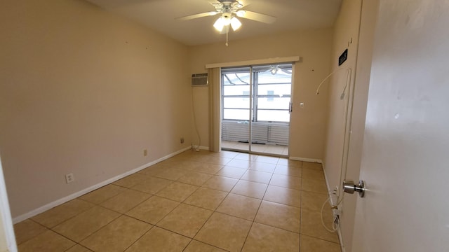 tiled empty room featuring ceiling fan and a wall unit AC