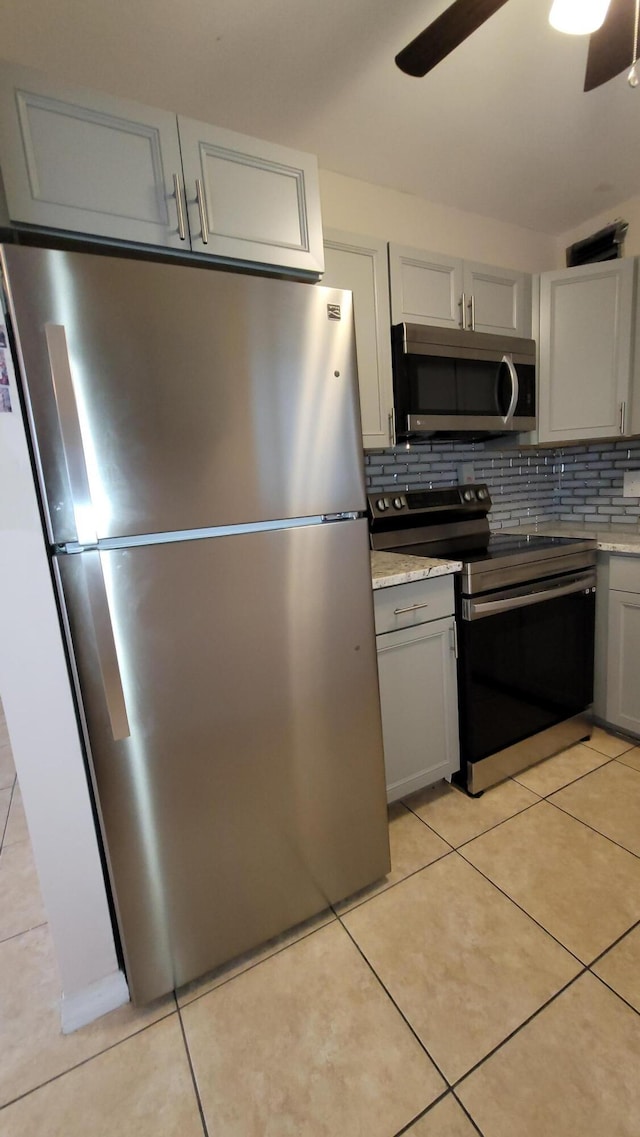 208 Easthampton I, West Palm Beach, FL 33417 - kitchen featuring appliances with stainless steel finishes, a ceiling fan, tasteful backsplash, light tile patterned floors, and gray cabinetry