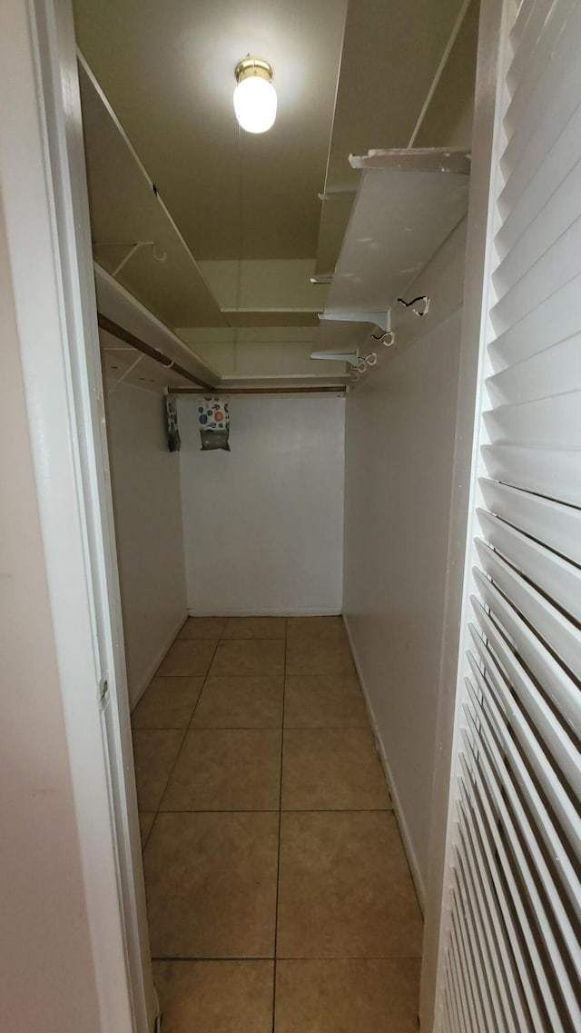 spacious closet featuring light tile patterned floors