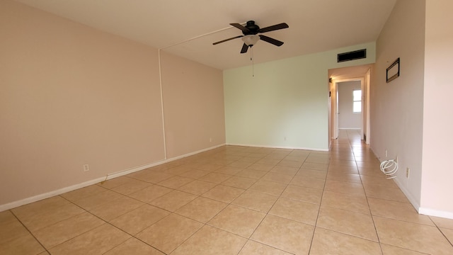 empty room featuring ceiling fan and light tile patterned floors