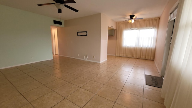 unfurnished room featuring light tile patterned floors and ceiling fan