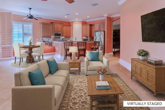 living room featuring ornamental molding, ceiling fan, and light tile patterned flooring