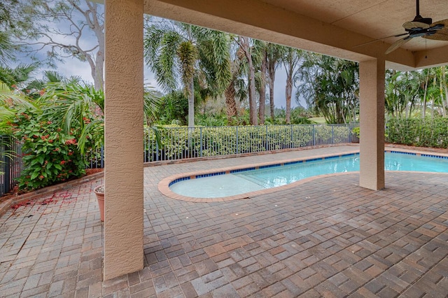 view of swimming pool featuring ceiling fan and a patio area