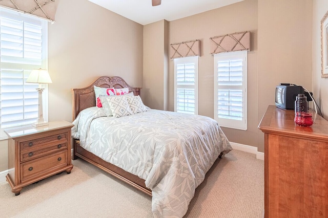 bedroom with light carpet and ceiling fan