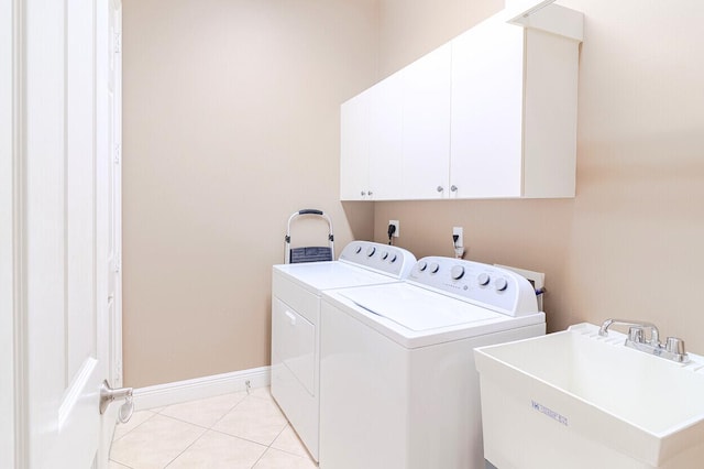 clothes washing area featuring cabinets, independent washer and dryer, sink, and light tile patterned floors