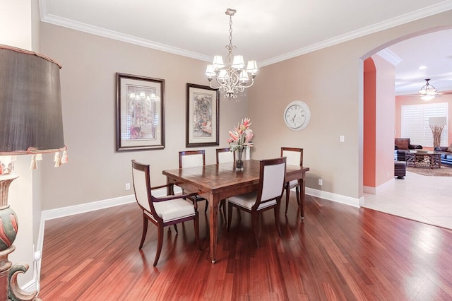 dining room with hardwood / wood-style floors, a notable chandelier, and ornamental molding