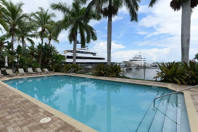 view of swimming pool featuring a water view