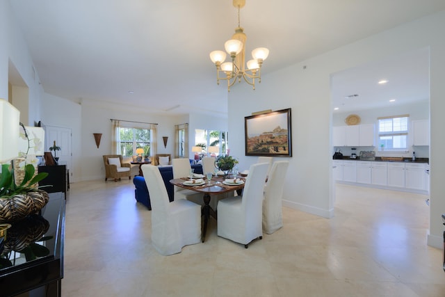 dining area with an inviting chandelier