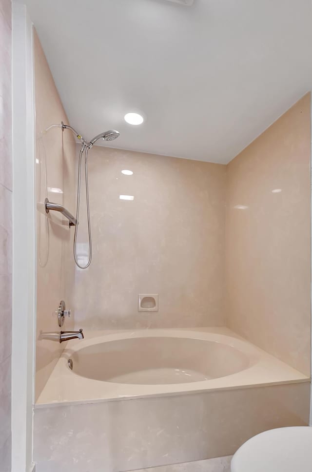 bathroom featuring toilet and tub / shower combination