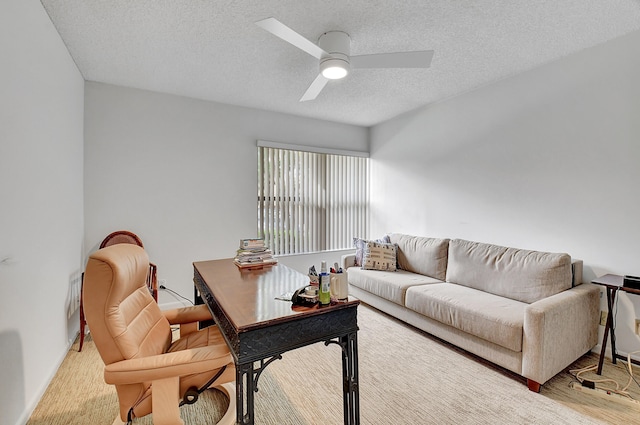 living room with a textured ceiling and ceiling fan