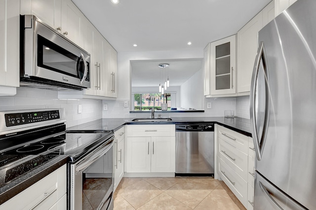 kitchen with sink, white cabinetry, decorative light fixtures, light tile patterned floors, and stainless steel appliances