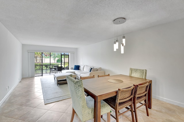 dining space with a textured ceiling and light tile patterned floors