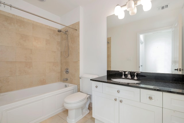 full bathroom featuring tile patterned floors, toilet, tiled shower / bath combo, and vanity