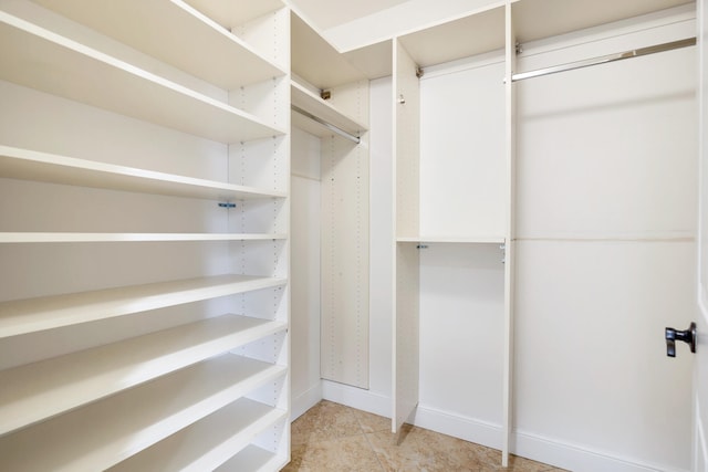 spacious closet with light tile patterned floors