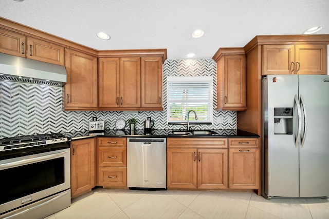 kitchen featuring backsplash, light tile patterned floors, stainless steel appliances, and sink