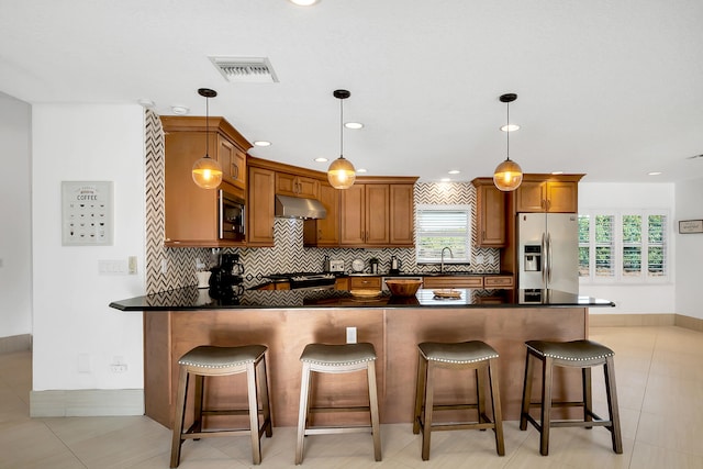 kitchen featuring a wealth of natural light, pendant lighting, and appliances with stainless steel finishes