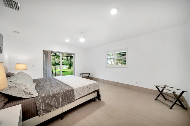 bedroom featuring multiple windows and access to outside