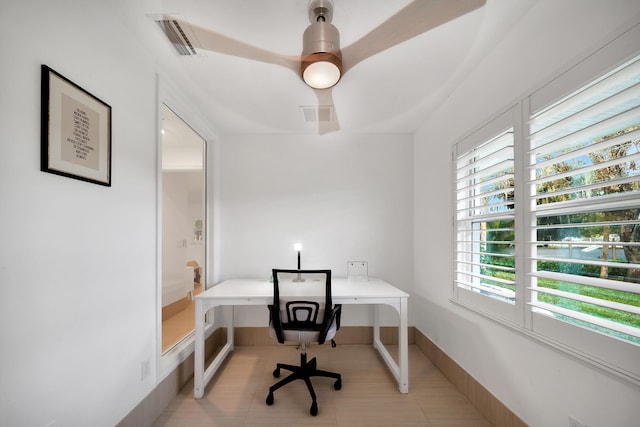 tiled office featuring ceiling fan