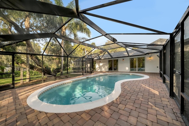 view of swimming pool with a patio and glass enclosure