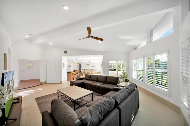 living room featuring ceiling fan, light tile patterned flooring, and lofted ceiling with beams