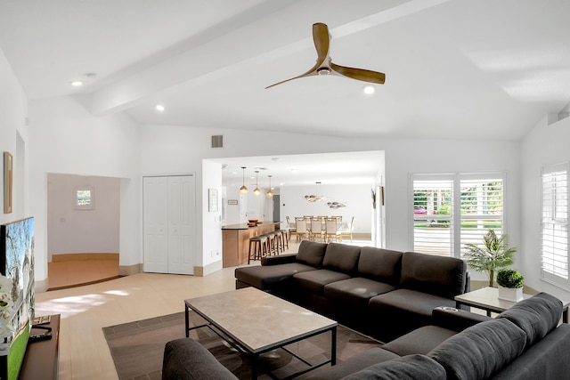 living room featuring lofted ceiling with beams, light hardwood / wood-style flooring, and ceiling fan