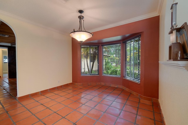 unfurnished dining area with visible vents, ornamental molding, arched walkways, light tile patterned floors, and baseboards