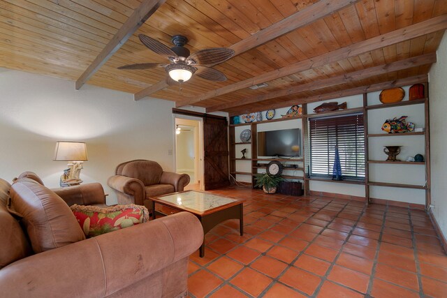 living room featuring beamed ceiling, a barn door, ceiling fan, and wood ceiling