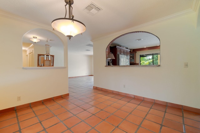 tiled empty room featuring arched walkways, visible vents, crown molding, and baseboards