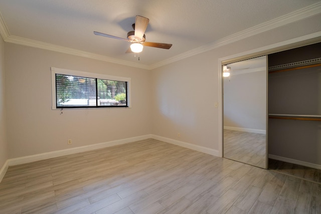 unfurnished bedroom with ceiling fan, light hardwood / wood-style floors, crown molding, and a closet