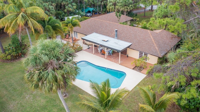 outdoor pool featuring a yard and a patio area