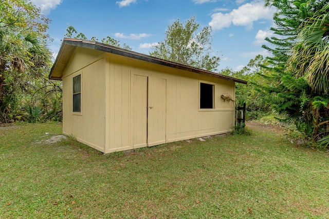 view of outdoor structure with a lawn