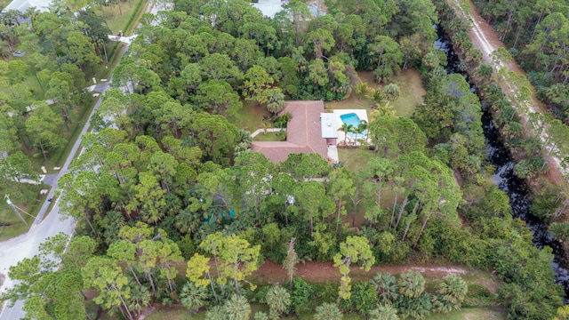 aerial view featuring a wooded view