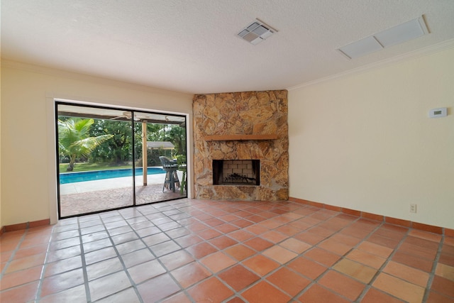 unfurnished living room with tile patterned flooring, a stone fireplace, and ornamental molding