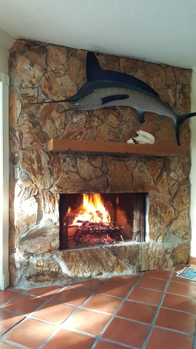 details with a stone fireplace and a textured ceiling