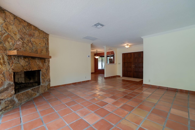 unfurnished living room with a fireplace, a textured ceiling, tile patterned floors, and crown molding