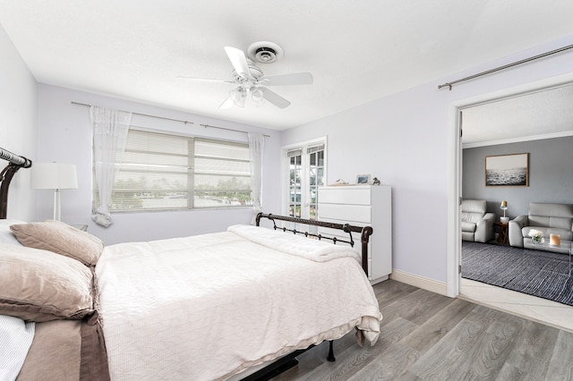 bedroom featuring crown molding, ceiling fan, and light hardwood / wood-style flooring