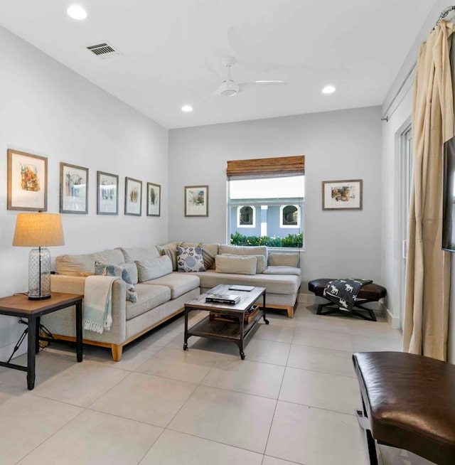 living room featuring ceiling fan and light tile patterned floors