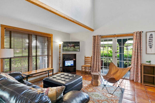 tiled living room with beam ceiling, french doors, and high vaulted ceiling