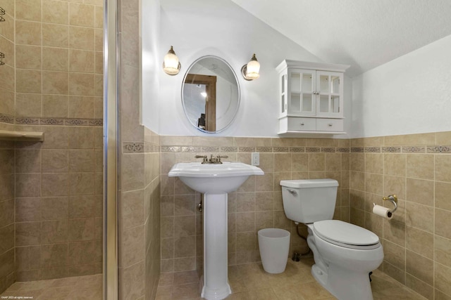 bathroom featuring tasteful backsplash, walk in shower, tile walls, toilet, and tile patterned flooring